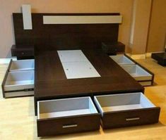 a bed with drawers underneath it in a room