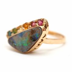 "A mini version of the rainbow opal peacock ring! Super colorful 6.1ct Austrailian boulder opal set in 14k yellow gold with a rainbow of tourmalines. Ring face measures 1/2\" x 7/8\". Ring size 6. Weighs 5.75 grams. Sizing available Layaway available" Fine Jewelry Multicolor Multi-stone Opal Ring, Multicolor Opal Multi-stone Rings, Multicolor Opal Ring, Peacock Ring, Boulder Opal Ring, Watch Cufflinks, Rainbow Opal, Bow Ring, Engagement Rings Opal