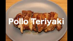 a white plate topped with meat and sauce on top of a wooden table next to the words poloo teriyaki