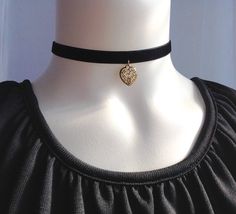 "This simple yet lovely choker features antique gold plated Heart cut-out American cast pewter charm and 10mm Black velvet ribbon or/ 1.8mm Black leather cord. It finishes with a lobster clasp and an additional 2\" extender chain. The Heart charm measures 0.55x0.62(14x16mm). ♥ Select your preferred materials and length at checkout. * Length include clasp. * Extender chain is not included in the length. ♥ You might also like the items below: https://www.etsy.com/ca/listing/1609977025/ https://www 90s Choker, Black Velvet Ribbon, Black Leather Choker, Choker Black, Black Velvet Choker, Heart Cut Out, Choker Pendant, Velvet Choker, Leather Chokers