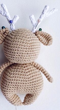 a crocheted stuffed animal with antlers on it's head and eyes