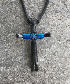 a black and blue necklace with a cross on it