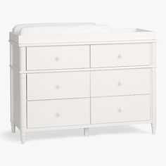 a white dresser with drawers and a baby crib next to it on a white background