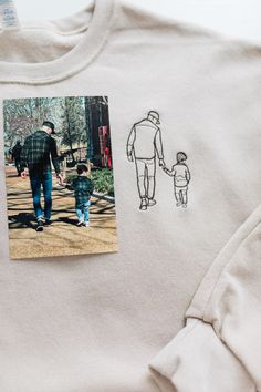 This Custom Embroidered Portrait Sweatshirt is customized using your own photo to make a unique gift! Your photo is digitized for embroidery in an outline form and embroidered right onto the sweatshirt!  Our custom portrait sweatshirts are the perfect way to showcase your favorite memories in a unique and stylish way. Whether it's a cherished family photo, a beloved pet, or a special moment captured in time, our sweatshirts can bring those images to life. Imagine walking around with your favorite photo printed on a cozy sweatshirt, creating a wearable piece of art that is sure to turn heads and spark conversations. With our high-quality printing and comfortable fabric, you can enjoy both style and comfort while showing off your personal touch. Embrace your individuality and make a statemen Embroidered Portrait, Custom Portrait, Cozy Sweatshirts, Custom Portraits, Gifts For Pet Lovers, Family Photo, Mom Gift, Fathers Day Gifts, Anniversary Gift