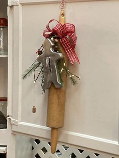 a christmas decoration hanging from the side of a cabinet with a wrench on it