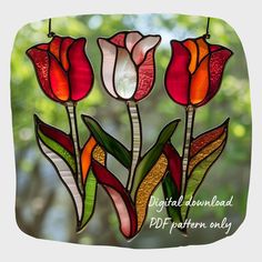 three stained glass tulips hanging from a string in front of a window with the words digital downloaded pdf pattern only