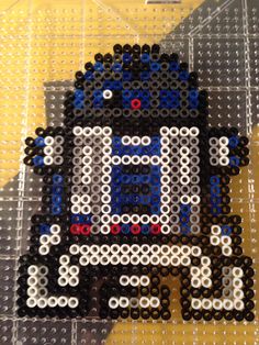 the pixel art is made out of legos and plastic beads, with an image of mega man on it