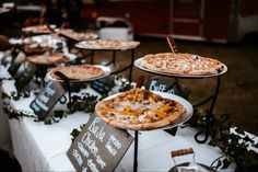 several pizzas are sitting on plates on a table