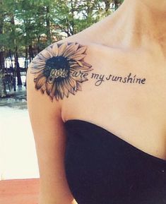 a woman with a sunflower tattoo on her arm that says you are my sunshine