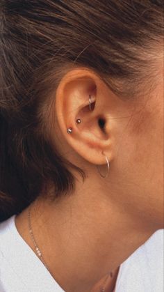 a woman with two piercings on her ear