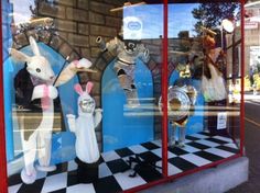 a store front window with stuffed animals in it