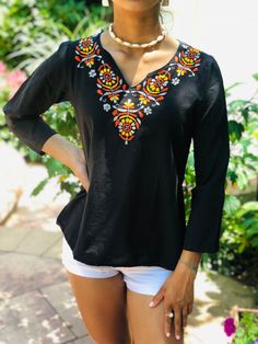 100% Cambric Black cotton top with Orange, Yellow, & Gray Embroidery.  Use As: Fashion top, Beach Cover up, Cotton Kurti, Cotton Tunic Features: A-line. Soft & breathable. Long sleeves. V-neck. Bohemian Embroidered Blouse; Retro Indian Ethnic Hippie Chic Top Care: Cold water machine wash; delicate cycle with embroidery side turned inside out. Hand wash is recommended. Should not be washed with bleach or detergents that contain bleach. Wash with like colors. Tumble dry on low heat or line dry. Ir Fall Split Neck Tunic, Traditional V-neck Top With Chikankari Embroidery, V-neck Top With Geometric Embroidery For Fall, Folk Style V-neck Top For Vacation, Traditional Embroidered V-neck Peasant Top, Embroidered Summer Tunic Top, Long Sleeve Tops With Geometric Embroidery For Summer, Floral Embroidered Tunic Top For Summer, Fall Cotton Tops With Chikankari Embroidery