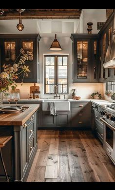 a kitchen with wooden floors and gray cabinets