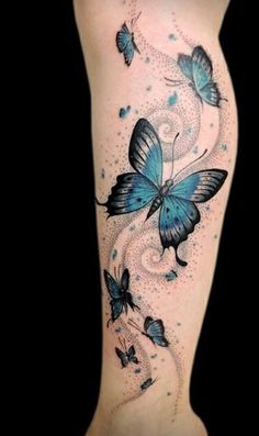 a woman's leg with blue butterflies on it