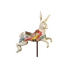 a statue of a white rabbit riding on top of a wooden pole with an orange ribbon around it's neck