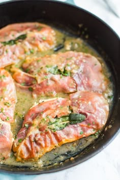 some food is cooking in a skillet on the stove top and ready to be eaten