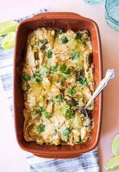 a casserole dish with chicken, vegetables and cheese in it on a table