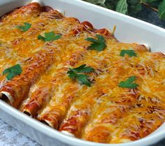 a casserole dish filled with cheese and meat, garnished with parsley