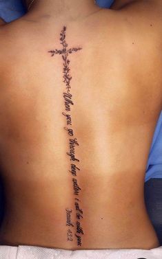 the back of a person with a cross tattoo