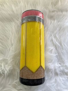 a yellow and red vase sitting on top of a white rug