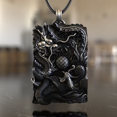 Experience the harmony of two of Asia's most iconic mythical creatures with our Dragon & Phoenix 925 Sterling Silver Necklace. This piece embodies the balance of yin and yang, representing the unity of opposites. The dragon, a symbol of strength, courage, and prosperity, intertwines with the phoenix, a symbol of renewal and rebirth. Expertly crafted from premium 925 sterling silver, the necklace showcases a detailed pendant reflecting the intricate artistry of Asian designs. Its unique design en Mythological Style Engraved Pendant Jewelry, Mythological Engraved Pendant Jewelry, Sterling Silver Amulet Necklace With Carved Details, Dragon Design Amulet Jewelry As Gift, Dragon Design Amulet Jewelry Gift, Amulet Jewelry With Dragon Design For Gift, Mythological Pendant Necklaces As Gifts, Antique Dragon Design Jewelry For Gift, Antique Dragon Design Jewelry Gift