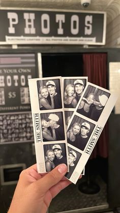 a person holding up four polaroid photos in front of a machine