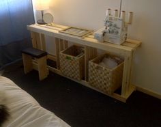 a room with a bed and some baskets on the floor next to a wall mounted clock