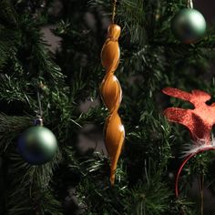 an ornament hanging from the top of a christmas tree