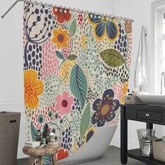 the shower curtain is decorated with colorful flowers and leaves on it's side wall