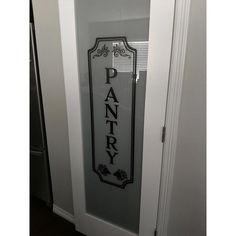 a pantry door with the word pantry painted on it's glass and black lettering