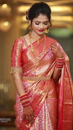 a woman in a red and gold sari