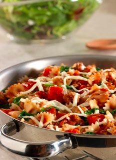 a pan filled with pasta and meat covered in cheese