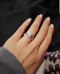 a woman's hand with a diamond ring on it