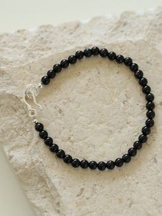 Add a touch of sophistication to your wrist with our Black Onyx Beaded Bracelet—a sleek and versatile accessory that seamlessly blends the timeless beauty of black onyx beads with a minimalist design. Metal: Recycled Sterling Silver Gemstone: Black Onyx 4mm Length: 170mm Weight: 5g Edison Pearls, Onyx Bead, Tiger Eye Stone, Black Agate, Deep Black, Recycled Sterling Silver, Agate Beads, Ring Bracelet, Stone Necklace