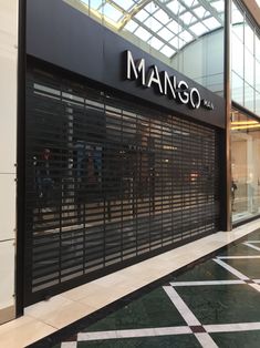 a man's store front with black shutters