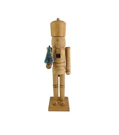 a wooden nutcracker holding a christmas tree