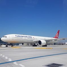 an airplane sitting on the tarmac at an airport