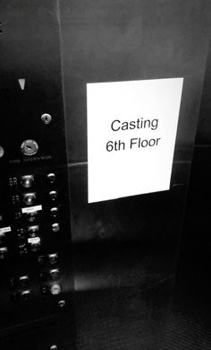 a black and white photo of an elevator with a sign on the door that says casting 6th floor