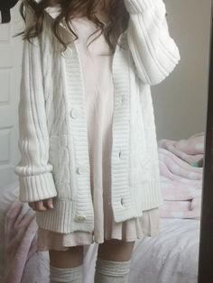 a girl in white sweater and knee high socks