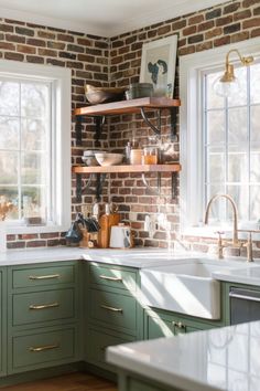 a kitchen with green cabinets and white counter tops in front of two windows that have open shelving above them