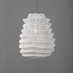 Enhance your space with this large white pendant featuring a distinctive accordion-like shade. Also available in black, this pendant creates a dazzling effect as light slips through the shade and dances across the walls and ceiling. Bulb not included.