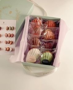 a box filled with lots of different types of pastries