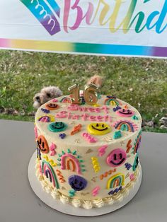 a decorated birthday cake sitting on top of a table