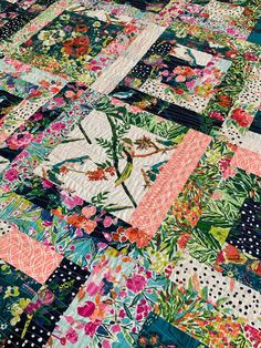 a patchwork quilt with flowers and polka dots