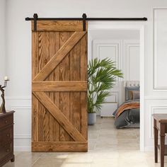 an open wooden sliding door in a white living room with wood furniture and potted plant