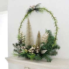 a christmas wreath with pine cones and greenery