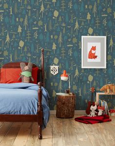 a child's bedroom with blue and green wallpaper, teddy bears and trees