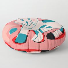 a cat sitting on top of a pink car floor pillow