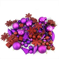 purple and red ornaments are arranged on a white surface