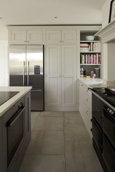 a kitchen with an oven, refrigerator and stove in it's center island area